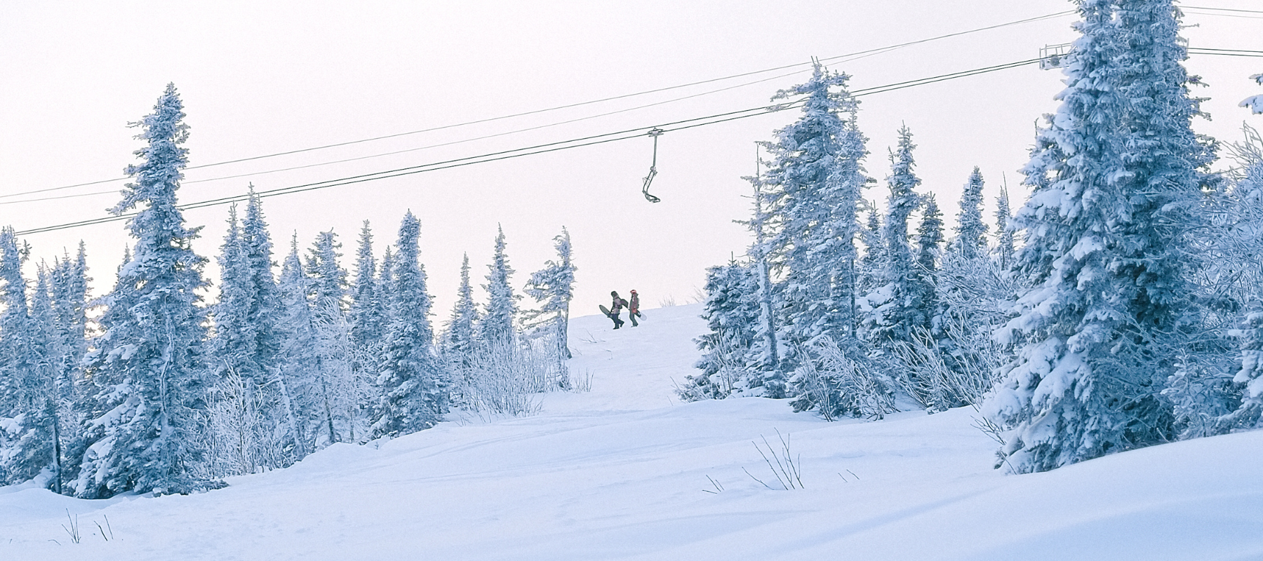 Snowboarders on ski hill during extreme cold weather