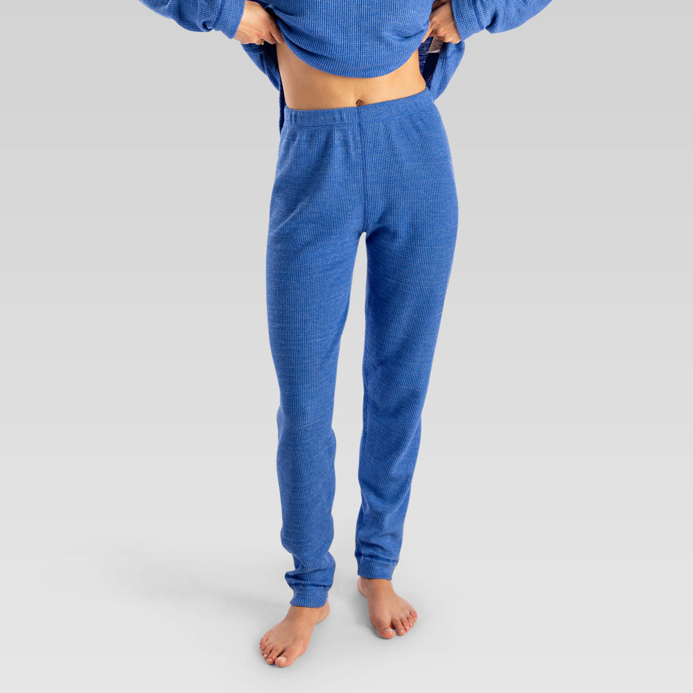 Person wearing blue sweatpants on a plain background