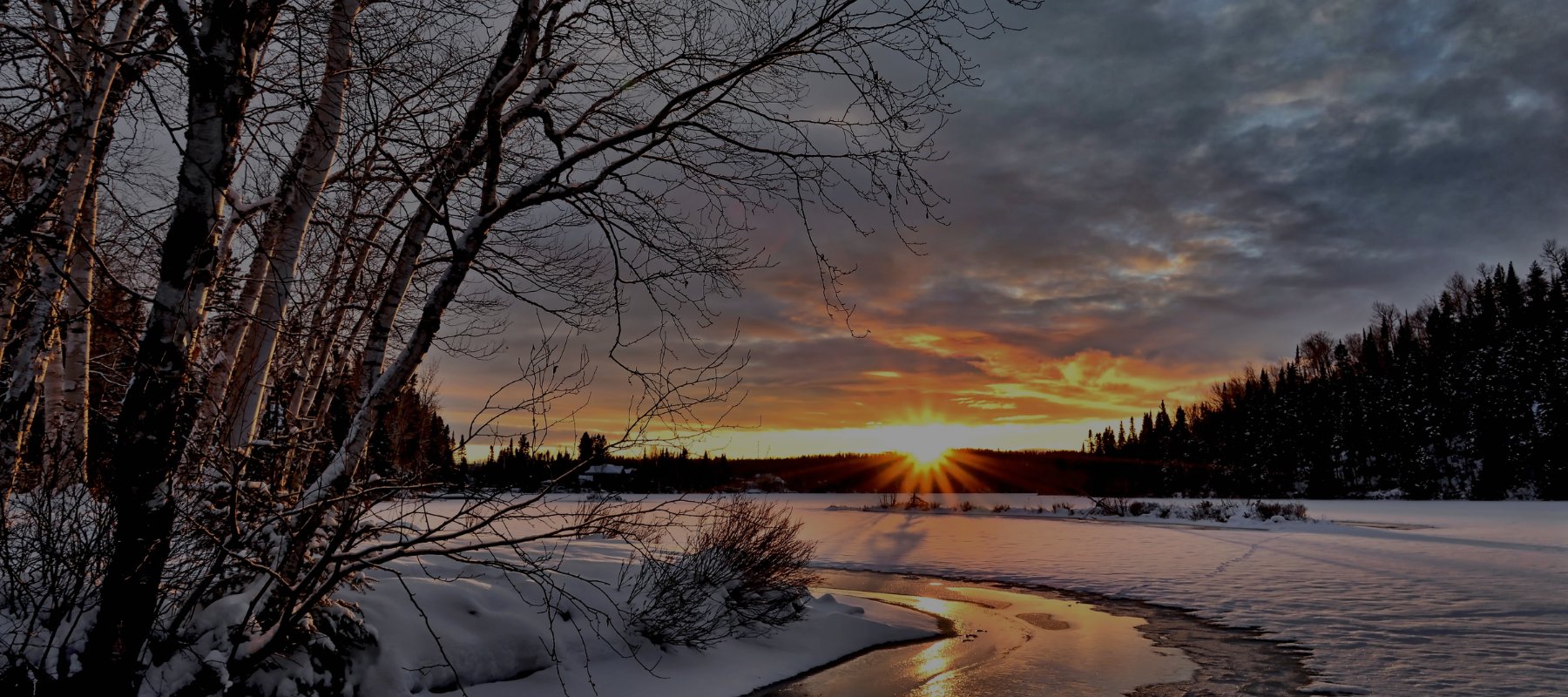Sunset over frozen river during winter
